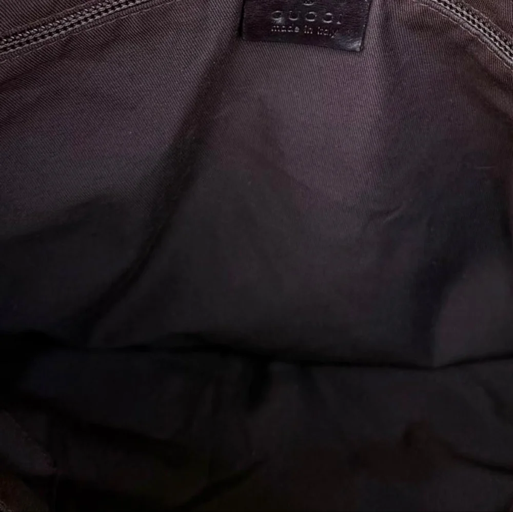 Gucci GG Monogram perforated leather messenger bag